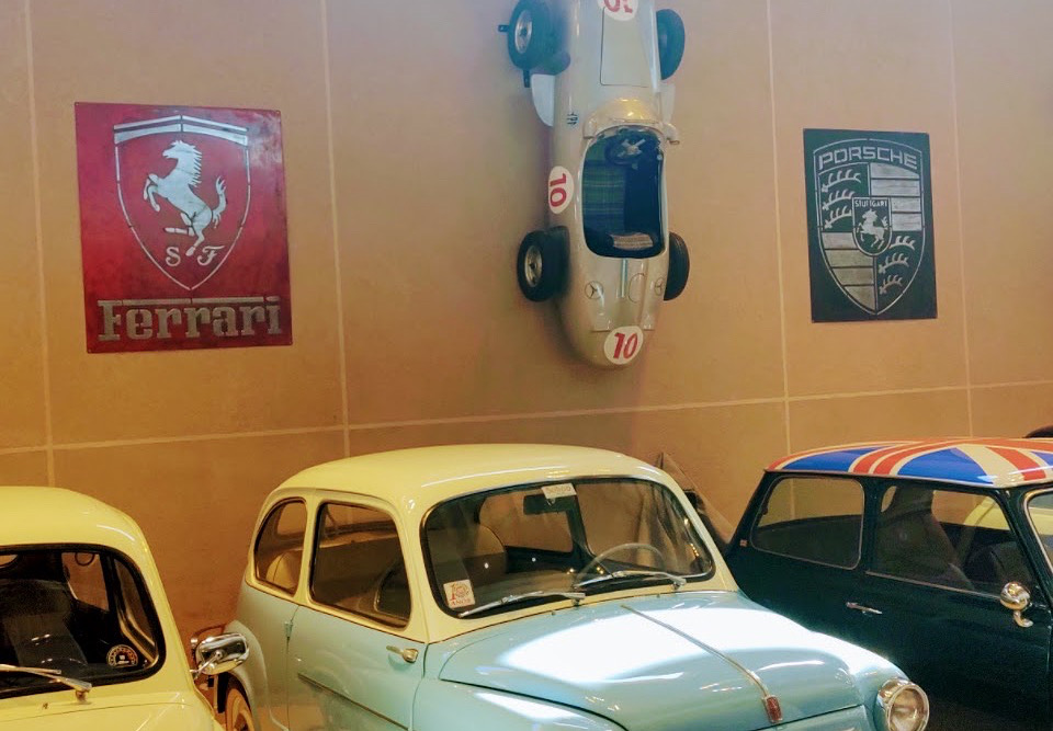 Handcrafted signs displayed in a classic-car collection