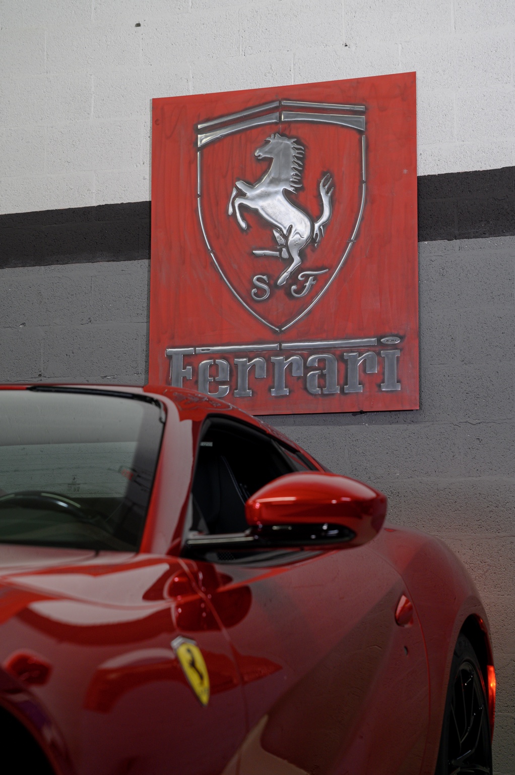 Ferrari sign displayed beside a customer’s car