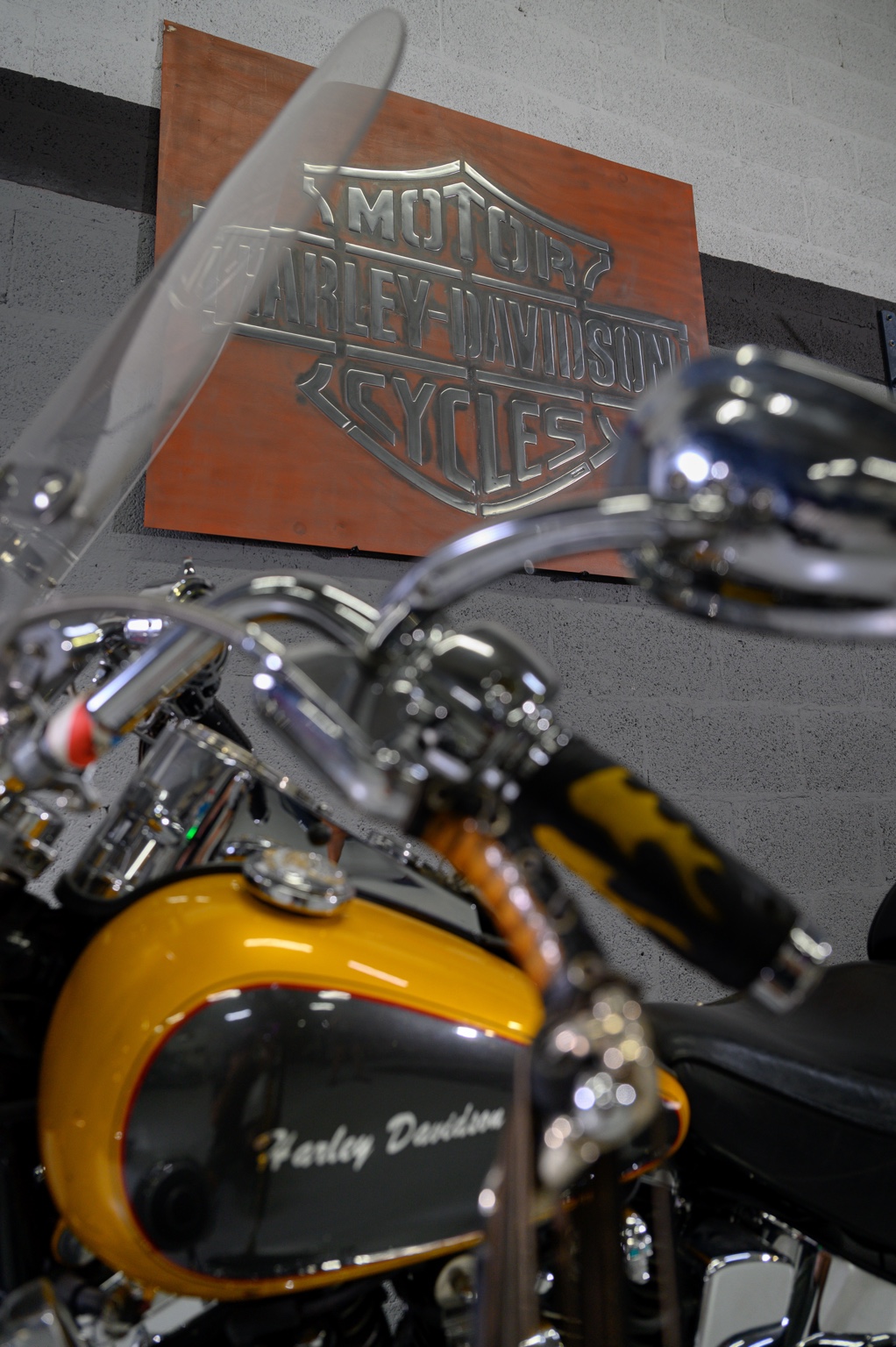 Handmade metal sign displayed above a customer motorcycle