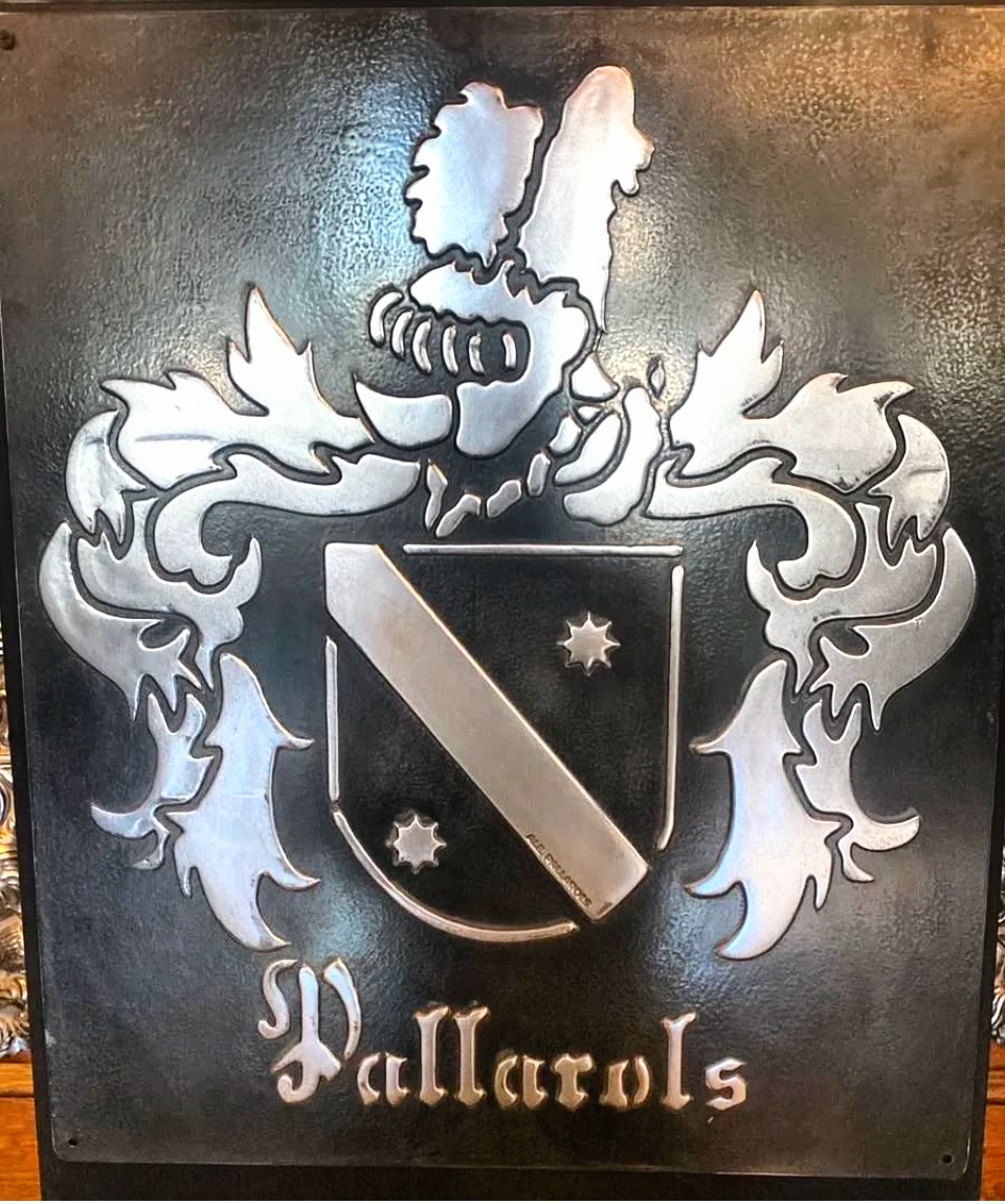 Muestra de portafolio de un escudo familiar Pallarols personalizado con relieve metálico